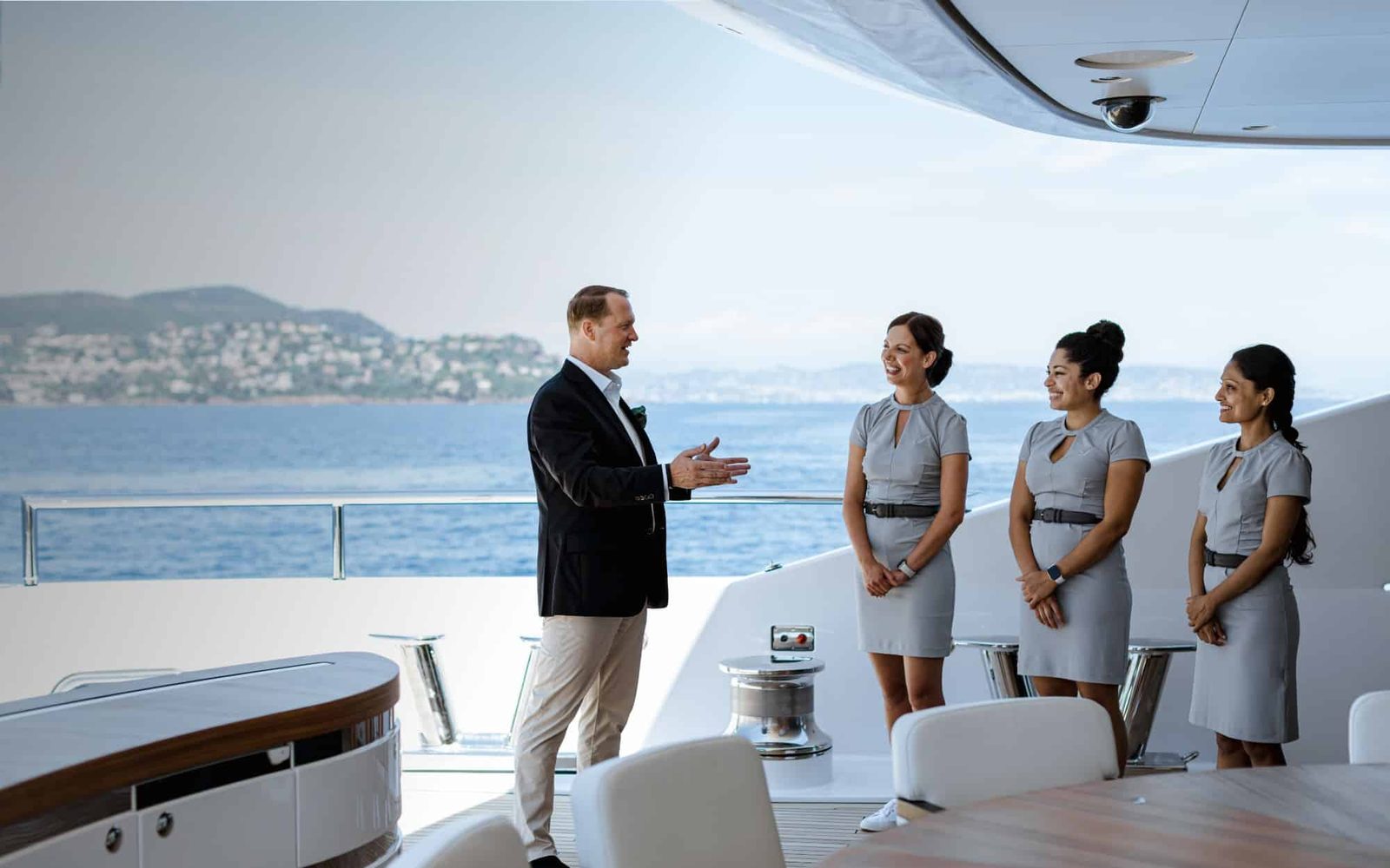 Crew attending guests aboard a yacht